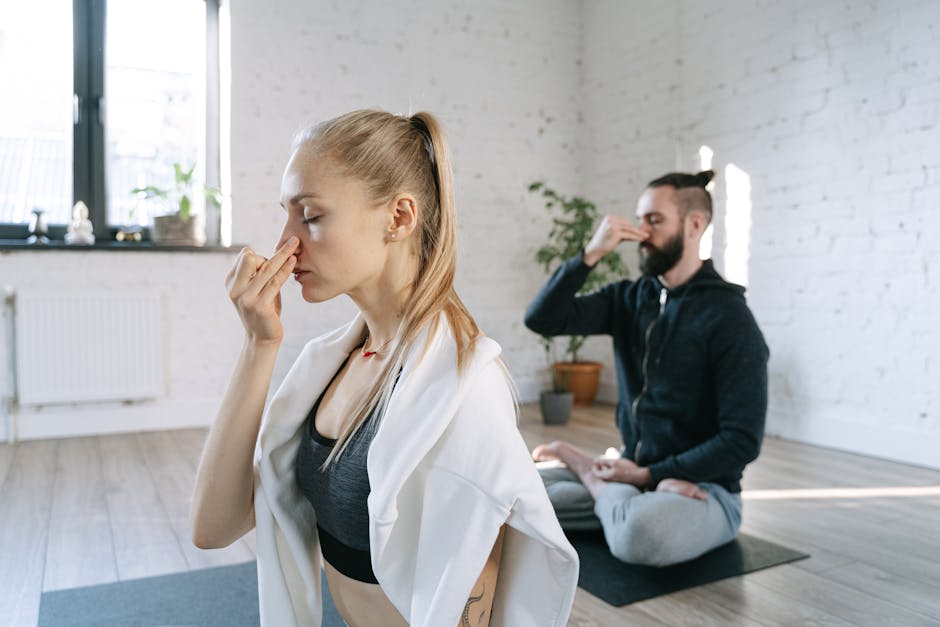 Woman meditating peacefully on a yoga mat in a sunlit, cozy room.